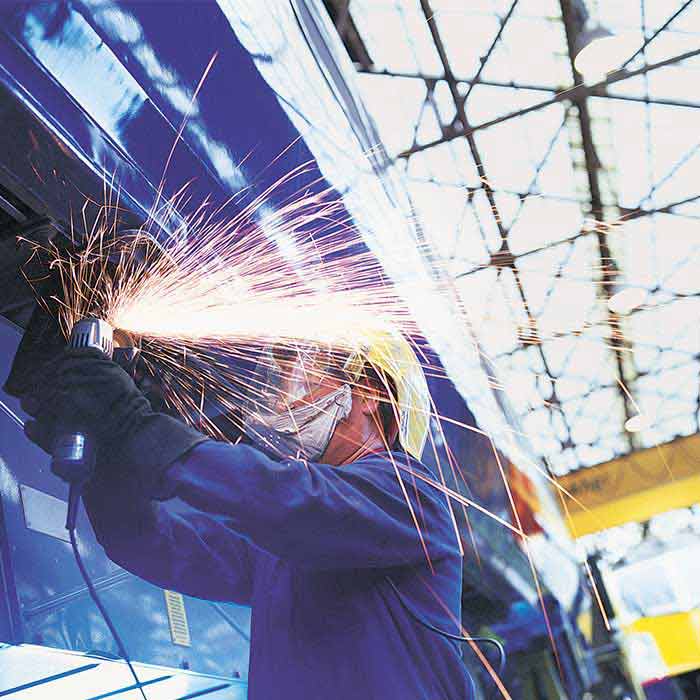 man with safety mask working in industrial facility